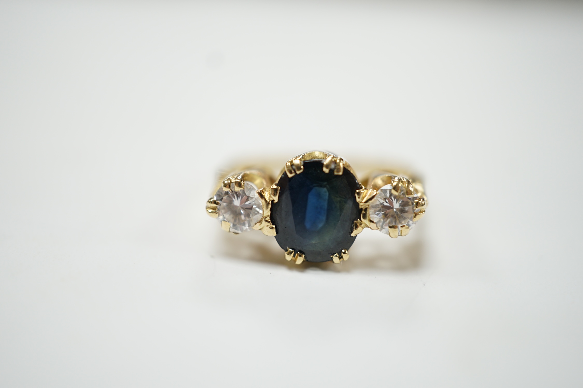 An 18ct, sapphire and diamond set three stone ring, size M/N, gross weight 4 grams. Fair condition.